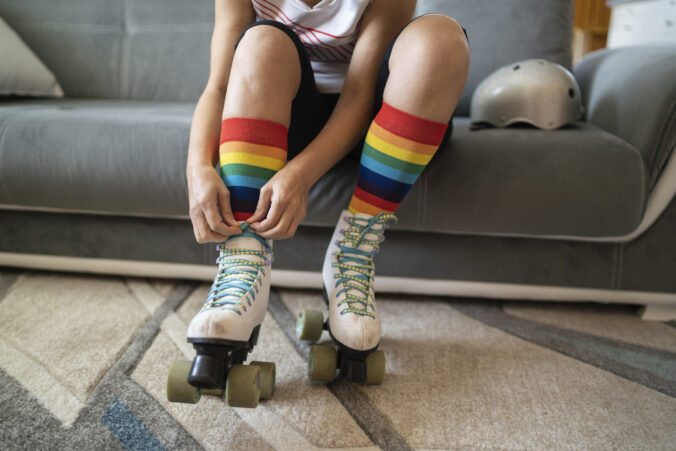 Close up of someone is tying the laces on roller skates